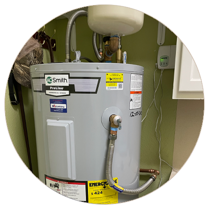 A.O. Smith ProLine electric water heater installed in a utility area with connected pipes and an expansion tank above.