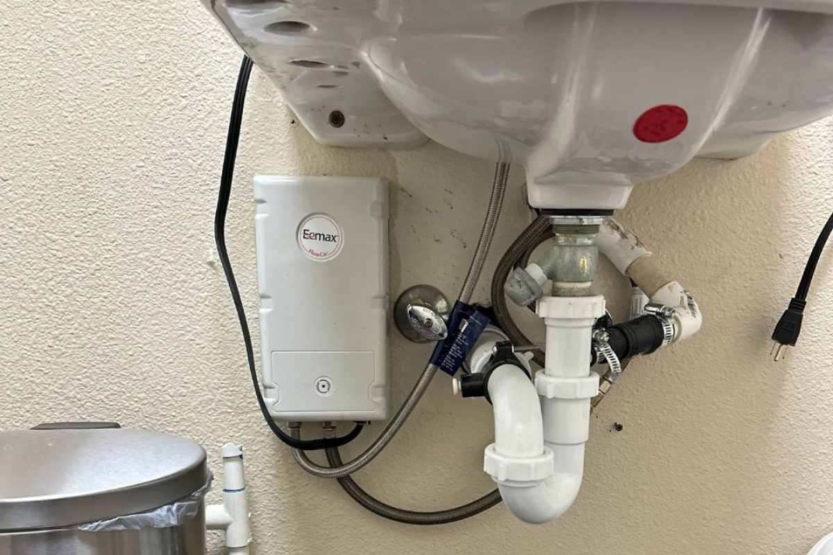 Eemax tankless water heater installed under sink.