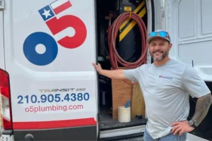 o5 plumbing technician next to the service truck