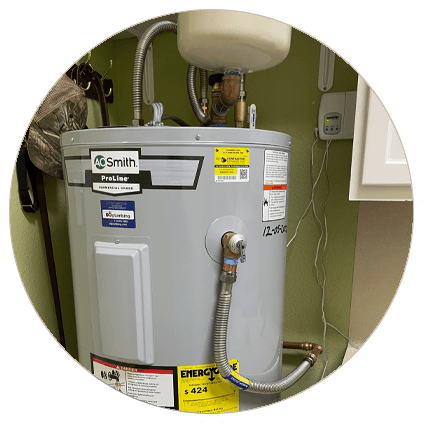 A.O. Smith ProLine electric water heater installed in a utility area with connected pipes and an expansion tank above.