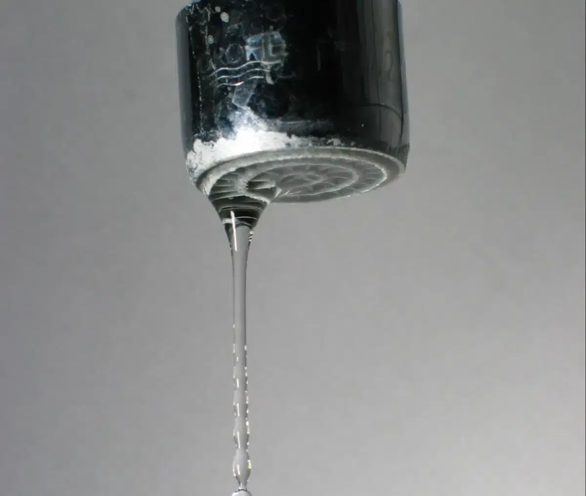 Close-up of a dripping faucet.