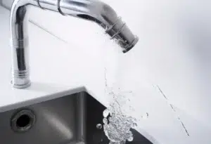 Modern kitchen faucet with running water.