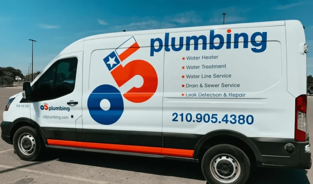 A side view of an O5 Plumbing service van, branded with the company logo and a list of plumbing services such as water heater repair, drain service, and leak detection.