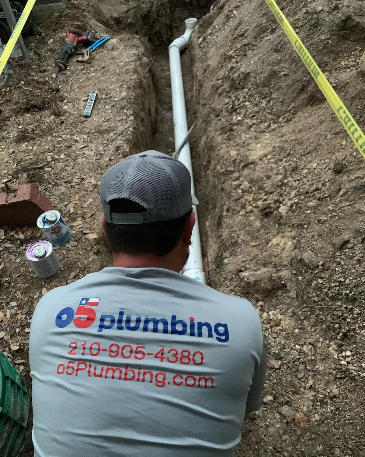 Yard Leak Detection in San Antonio 2 Plumber working on pipe installation in trench.
